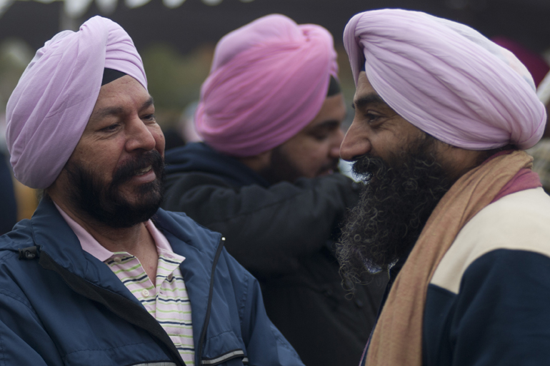 Sikhs Narvinder and Maninder Singh talk before the Making Strides Against Breast Cancer 5K walk downtown, Saturday, Oct. 26, 2013.