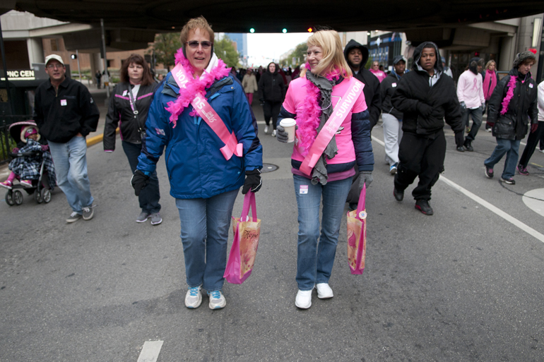 Sharon Berger and Susan Capshaw, both breast cancer survivors, walk under the Artsgarden during the Making Strides Against Breast Cancer 5K walk downtown, Saturday, Oct. 26, 2013. Capshaw has been in remission for six years, while Berger survived her second bout of breast cancer three years ago and has been fighting for 10 years total.