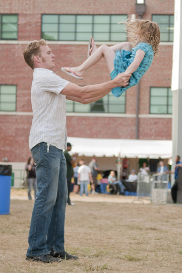 Kenan Rainwater twirls his daughter Eleanor after she walked up his chest in a dance routine during Jennie DeVoe\'s performance on Hoosier Night on the Marsh Free Stage at the Indiana State Fair, Friday, August 16, 2013.