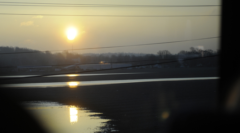 The sun rises over southern Indiana as students from Indiana University return from the Indianapolis International Airport after their canceled class trip to Japan on Mar. 11, 2011, on Indiana State Road 39. (Alex Farris)