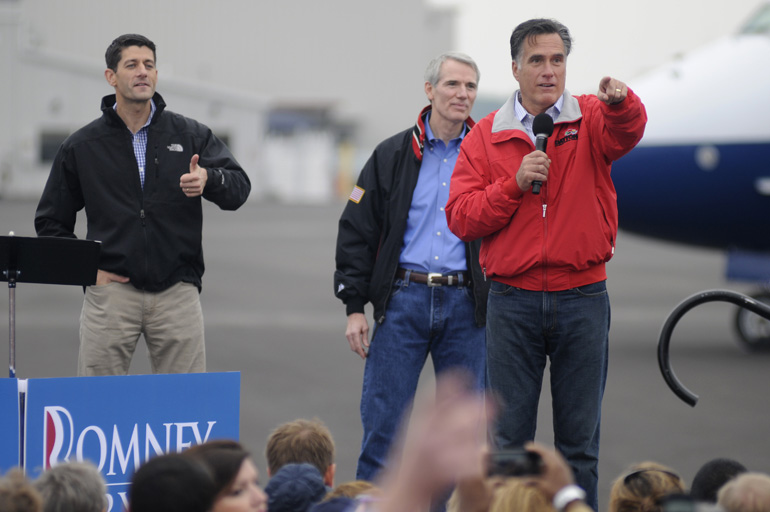 Former Mass. governor Mitt Romney thanks Lee Greenwood for his performance during a Romney/Ryan presidential campaign stop Sept. 25 at Dayton International Airport Exposition Center in Ohio.