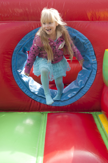 Ava Caserotti, 6, climbs out of an inflatable obstacle course during the Riley Hospital for Children Neonatal Intensive Care Unit Reunion at Fairbanks Hall, Saturday, Sept. 13, 2014. Caserotti was born three months premature and stayed in the NICU for three months.