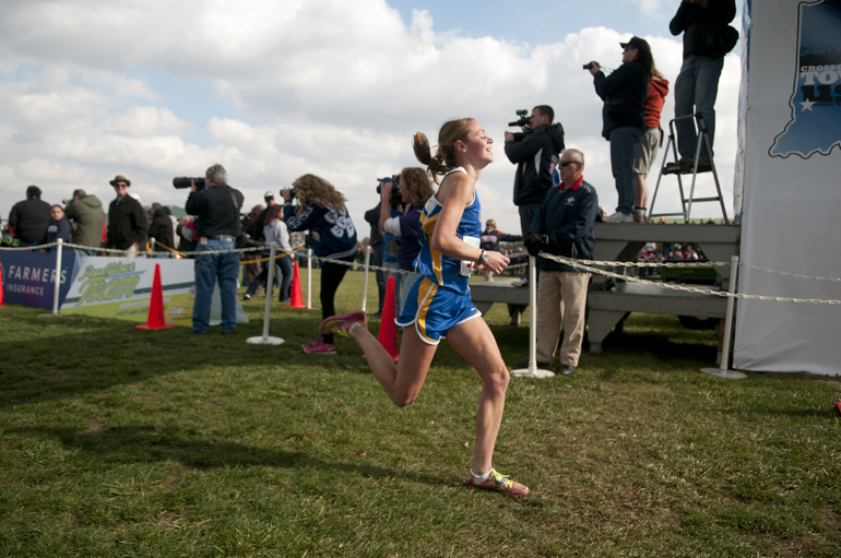 Kelcy Welch of Carmel smiles as she crosses the finish line in first place during the 33rd IHSAA Cross Country State Finals in Terre Haute, Saturday, Nov. 2, 2013.