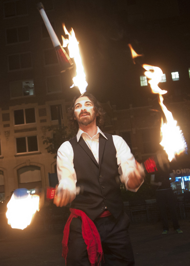 Norm Weingart of Bloomington\'s Hudsucker Posse juggles torches during the inaugural Hallow\'s Eve benefit for Easter Seals Crossroads at City Market, Saturday, Oct. 25, 2014.