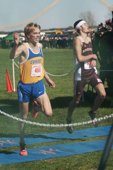 Carmel junior Ben Veatch beats Brebeuf senior Zack Snider over the finish line in first place during the IHSAA Boys Cross Country State Finals at LaVern Gibson Championship Cross Country Course in Terre Haute, Saturday, Nov. 1, 2014.